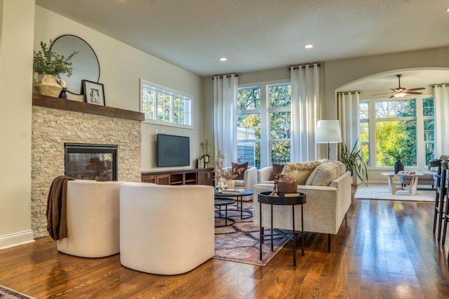 17796 Junelle Ct, Lakeville, MN 55044 - living room with wood finished floors, ceiling fan, arched walkways, a fireplace, and recessed lighting