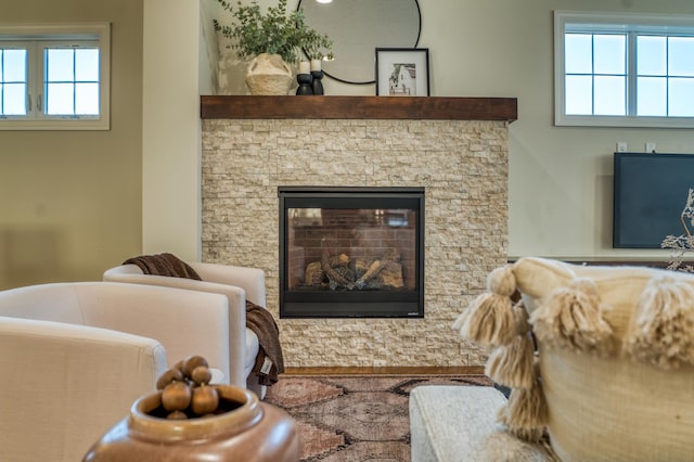 17796 Junelle Ct, Lakeville, MN 55044 - living area featuring healthy amount of natural light, a stone fireplace, and wood finished floors
