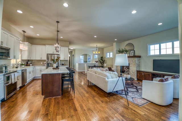 17796 Junelle Ct, Lakeville, MN 55044 - kitchen featuring appliances with stainless steel finishes, open floor plan, healthy amount of natural light, a chandelier, and recessed lighting