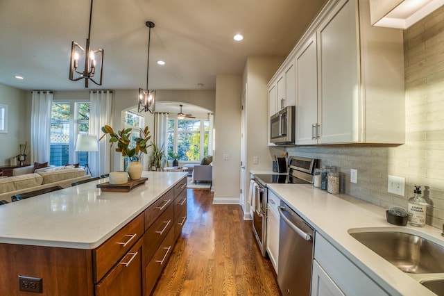 17796 Junelle Ct, Lakeville, MN 55044 - kitchen with stainless steel appliances, open floor plan, healthy amount of natural light, dark wood finished floors, and recessed lighting