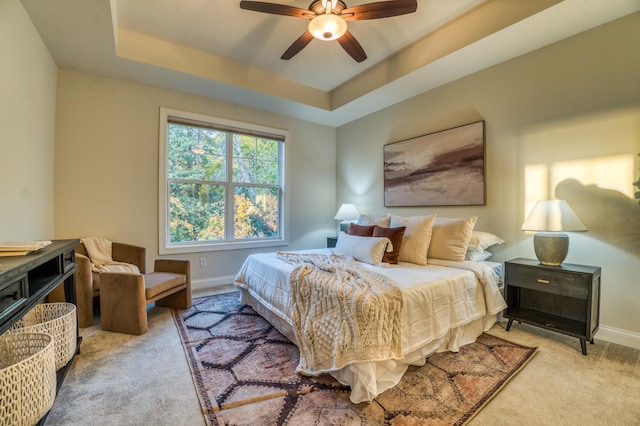 17796 Junelle Ct, Lakeville, MN 55044 - bedroom featuring carpet, baseboards, a tray ceiling, and ceiling fan