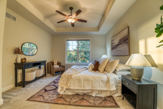 17796 Junelle Ct, Lakeville, MN 55044 - bedroom featuring light carpet, a raised ceiling, ceiling fan, and baseboards