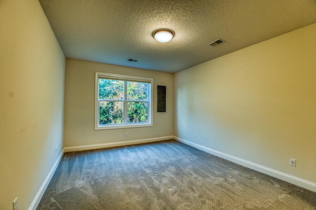 17796 Junelle Ct, Lakeville, MN 55044 - empty room featuring a textured ceiling, dark carpet, and baseboards