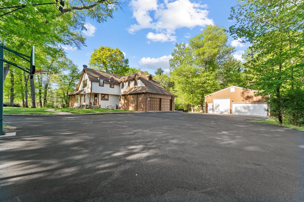 13746 Furman St NE, Columbus, MN 55025 - tudor-style house featuring a garage and an outbuilding