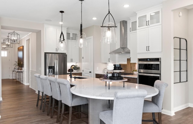 10045 Mulberry, Corcoran, MN 55374 - kitchen featuring wall chimney exhaust hood, appliances with stainless steel finishes, a sink, dark wood-style flooring, and baseboards