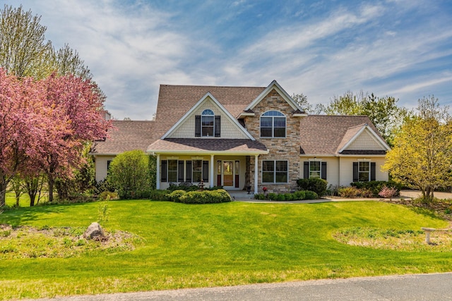 770 Valley View Rd SW, Oronoco, MN 55960 - view of front facade with stone siding, a front yard, and roof with shingles