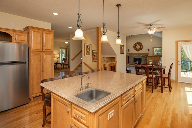 770 Valley View Rd SW, Oronoco, MN 55960 - kitchen featuring freestanding refrigerator, a sink, light wood-style floors, ceiling fan, and recessed lighting