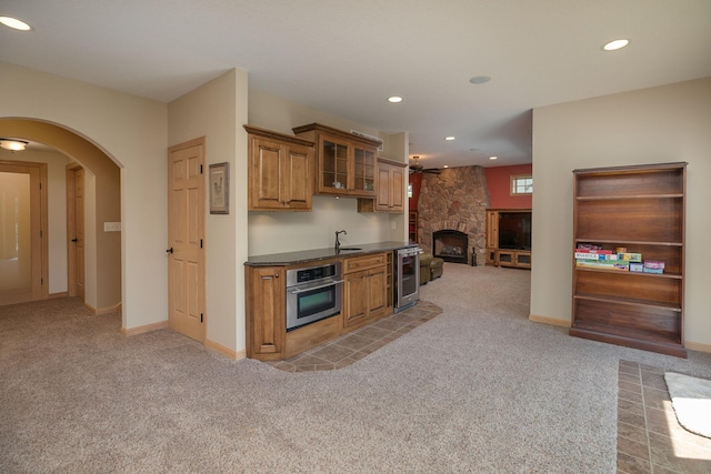 770 Valley View Rd SW, Oronoco, MN 55960 - kitchen with stainless steel oven, wine cooler, light carpet, brown cabinets, and recessed lighting