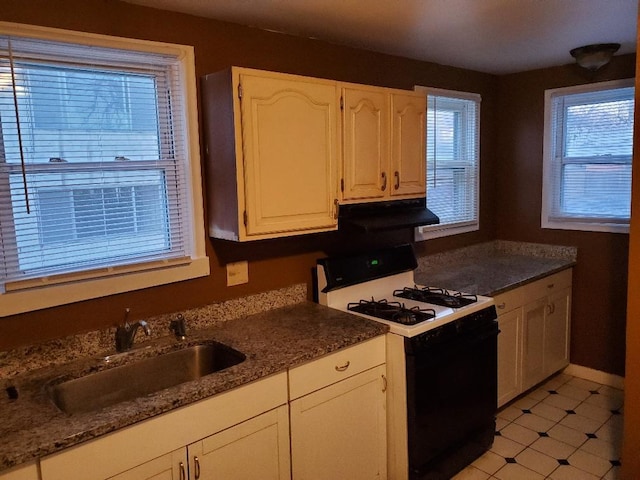 4422 Bryant Ave N, Minneapolis, MN 55412 - kitchen featuring gas range oven, a sink, white cabinetry, and under cabinet range hood