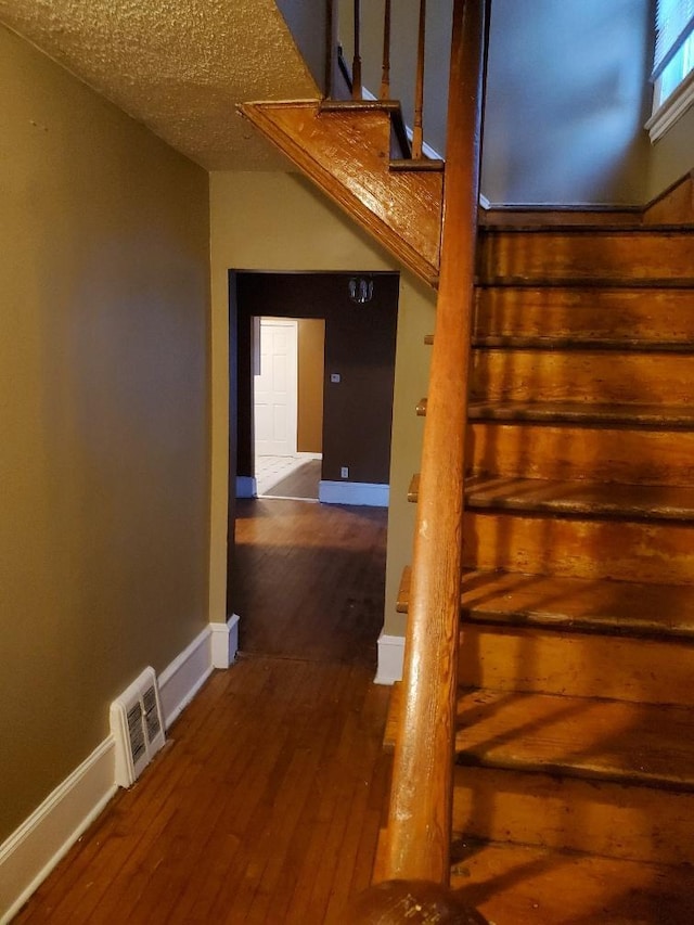 4422 Bryant Ave N, Minneapolis, MN 55412 - stairs featuring hardwood / wood-style floors and baseboards