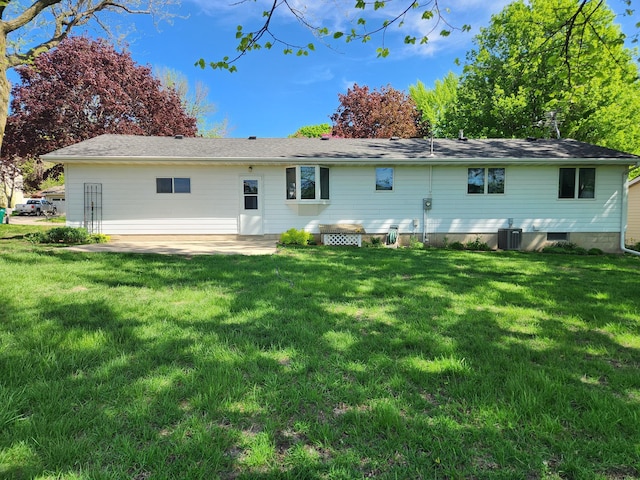 rear view of house with central air condition unit, a yard, and a patio