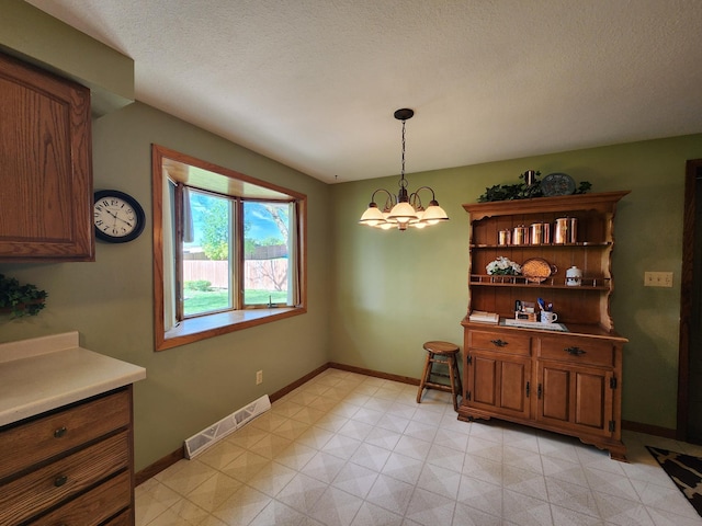 dining room featuring baseboards and a chandelier