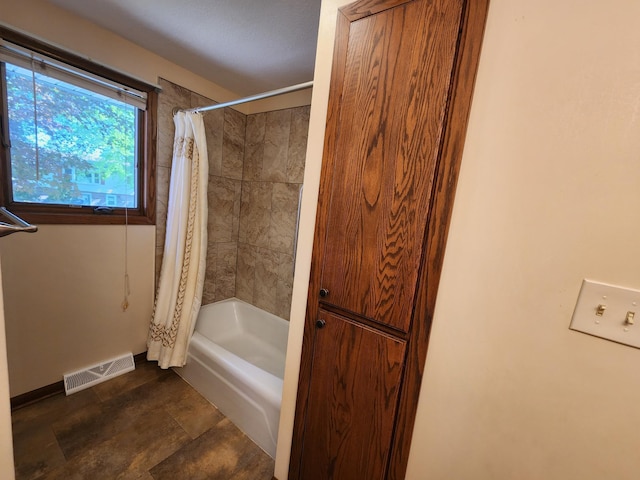 full bathroom featuring baseboards and shower / bath combination with curtain