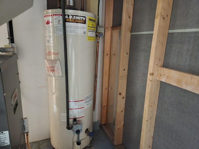 utility room featuring water heater