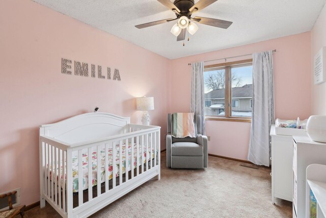 14870 Endicott Way Unit 20, Apple Valley, MN 55124 - bedroom featuring carpet, a crib, ceiling fan, and baseboards