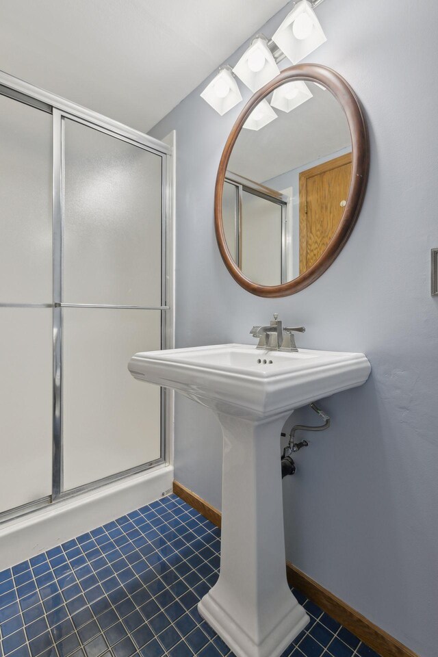 14870 Endicott Way Unit 20, Apple Valley, MN 55124 - bathroom featuring tile patterned flooring, a stall shower, baseboards, and a sink