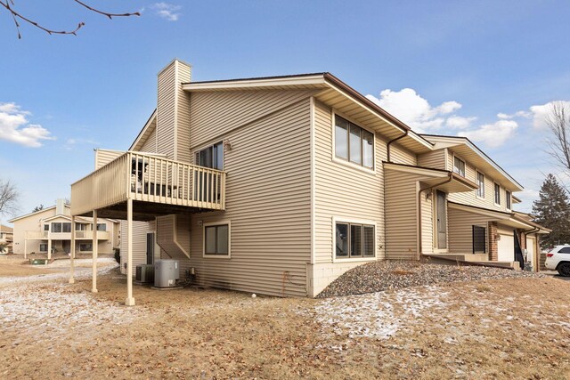 14870 Endicott Way Unit 20, Apple Valley, MN 55124 - view of property exterior featuring central air condition unit, a chimney, and a deck