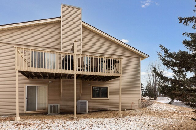 14870 Endicott Way Unit 20, Apple Valley, MN 55124 - rear view of house featuring a wooden deck, central air condition unit, and a chimney