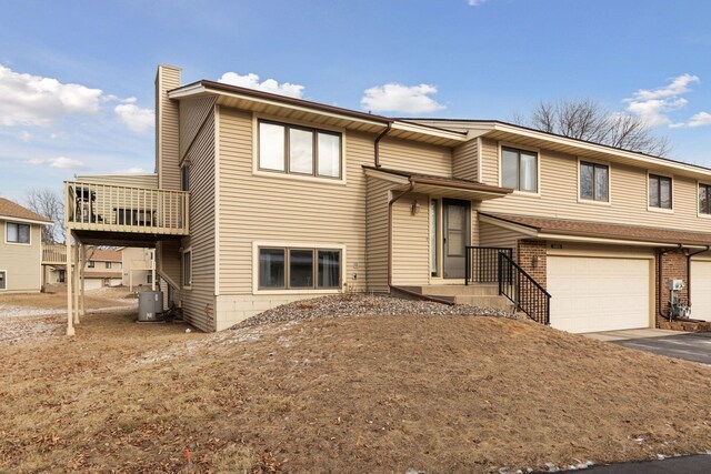14870 Endicott Way Unit 20, Apple Valley, MN 55124 - view of front facade featuring a chimney, an attached garage, and asphalt driveway