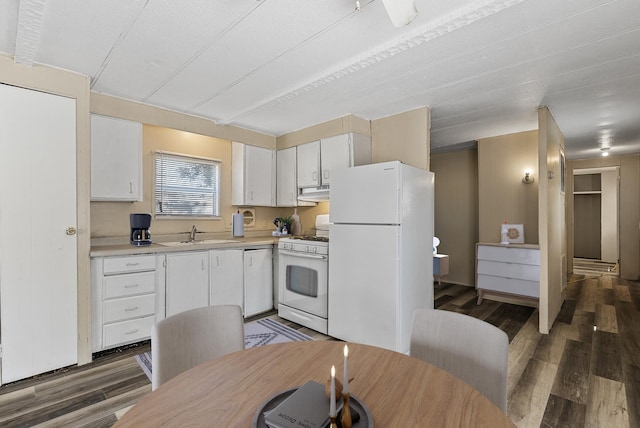 501 Forest St Unit 18, Belle Plaine, MN 56011 - kitchen featuring white appliances, light countertops, white cabinets, under cabinet range hood, and wood finished floors
