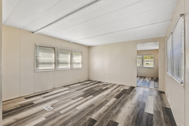 501 Forest St Unit 18, Belle Plaine, MN 56011 - unfurnished room featuring wood finished floors and a textured ceiling