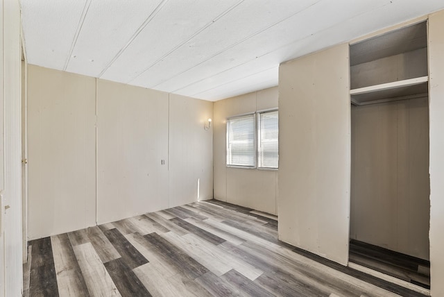 501 Forest St Unit 18, Belle Plaine, MN 56011 - unfurnished bedroom featuring wood finished floors and a closet