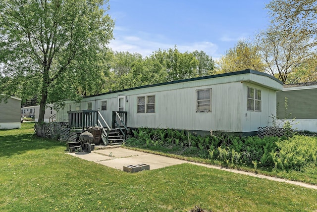 501 Forest St Unit 18, Belle Plaine, MN 56011 - back of property with a lawn, a patio, and a deck