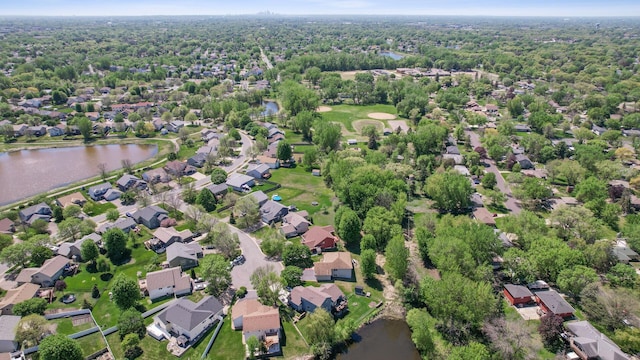 aerial view of property's location featuring a nearby body of water and nearby suburban area