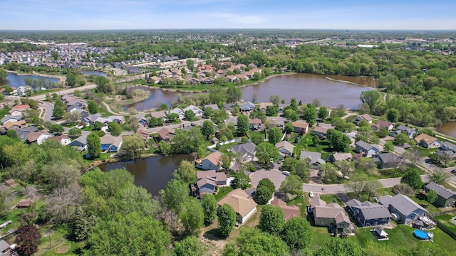 aerial view of property's location with a nearby body of water and nearby suburban area