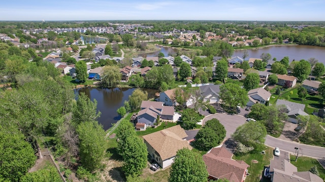 aerial view of property's location featuring a nearby body of water and nearby suburban area
