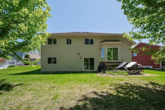 rear view of property with a yard