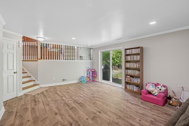 game room featuring crown molding, wood finished floors, baseboards, and recessed lighting