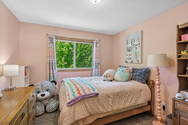 bedroom featuring carpet flooring and a textured ceiling
