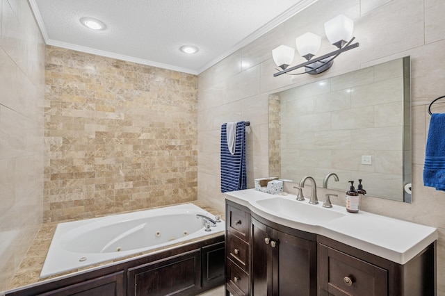 bathroom featuring ornamental molding, tile walls, a textured ceiling, a tub with jets, and vanity