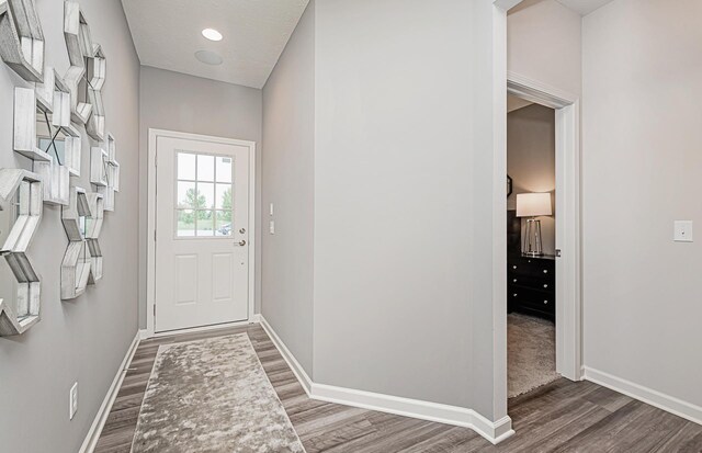 9997 Mulberry Ln, Corcoran, MN 55374 - doorway to outside featuring wood finished floors and baseboards