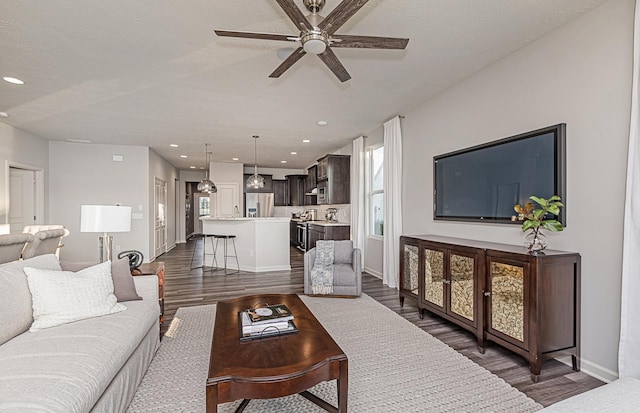 9997 Mulberry Ln, Corcoran, MN 55374 - living room featuring a ceiling fan, healthy amount of natural light, dark wood finished floors, recessed lighting, and a textured ceiling