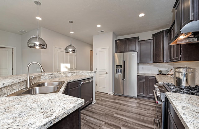9997 Mulberry Ln, Corcoran, MN 55374 - kitchen featuring stainless steel appliances, a sink, dark brown cabinetry, dark wood-style flooring, and hanging light fixtures
