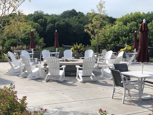 9997 Mulberry Ln, Corcoran, MN 55374 - view of patio / terrace with a fire pit, fence, and outdoor dining space