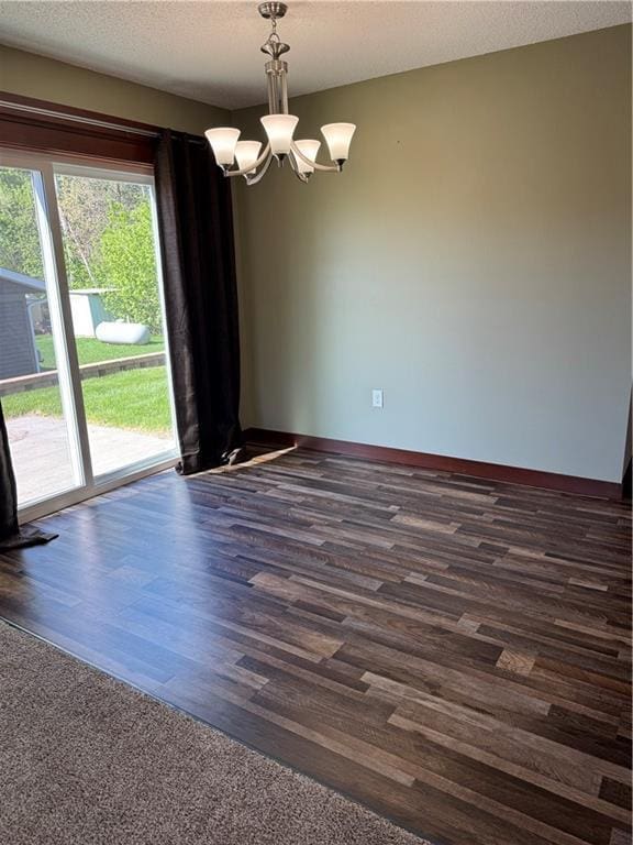 169 Amber View St, Menomonie, WI 54751 - spare room featuring a chandelier, baseboards, and dark wood-style floors