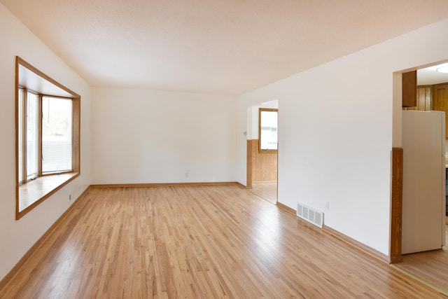 empty room with light wood finished floors and baseboards