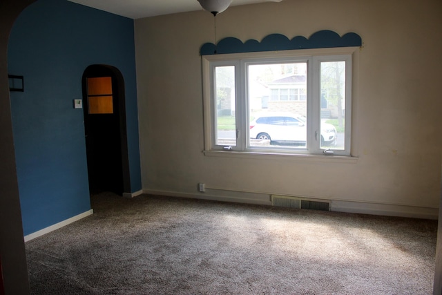 2612 3rd Ave W, Hibbing, MN 55746 - carpeted spare room featuring arched walkways and ceiling fan