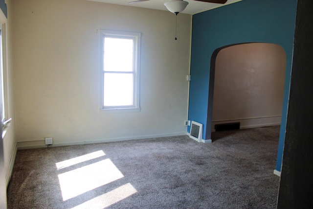2612 3rd Ave W, Hibbing, MN 55746 - empty room featuring carpet, ceiling fan, and arched walkways