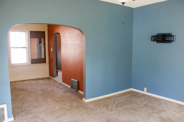 2612 3rd Ave W, Hibbing, MN 55746 - unfurnished room featuring carpet flooring, arched walkways, and ceiling fan