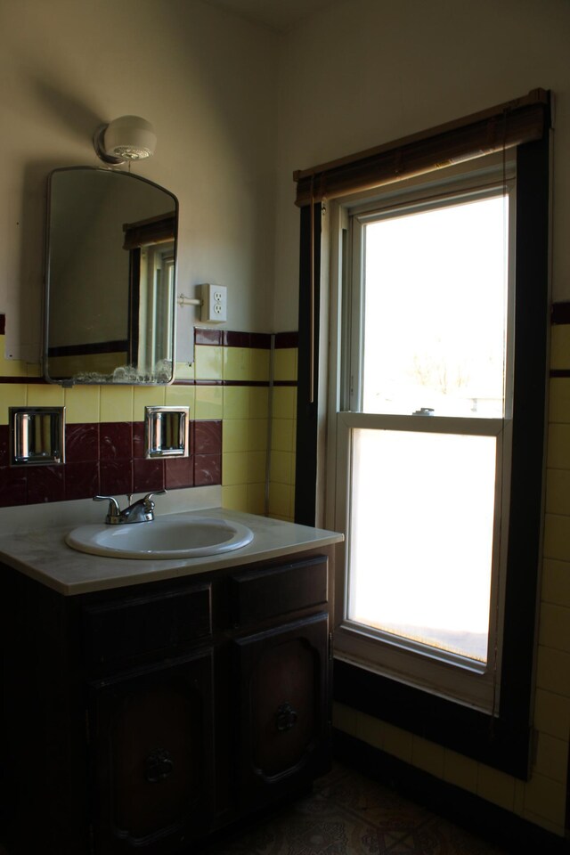 2612 3rd Ave W, Hibbing, MN 55746 - bathroom with vanity, tile walls, and wainscoting