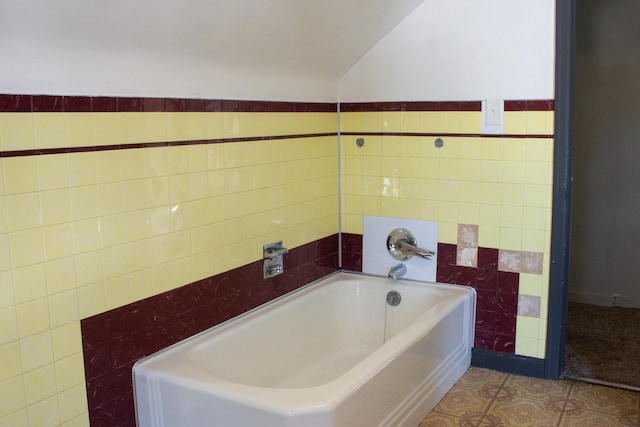 2612 3rd Ave W, Hibbing, MN 55746 - bathroom with tile walls, a garden tub, and lofted ceiling