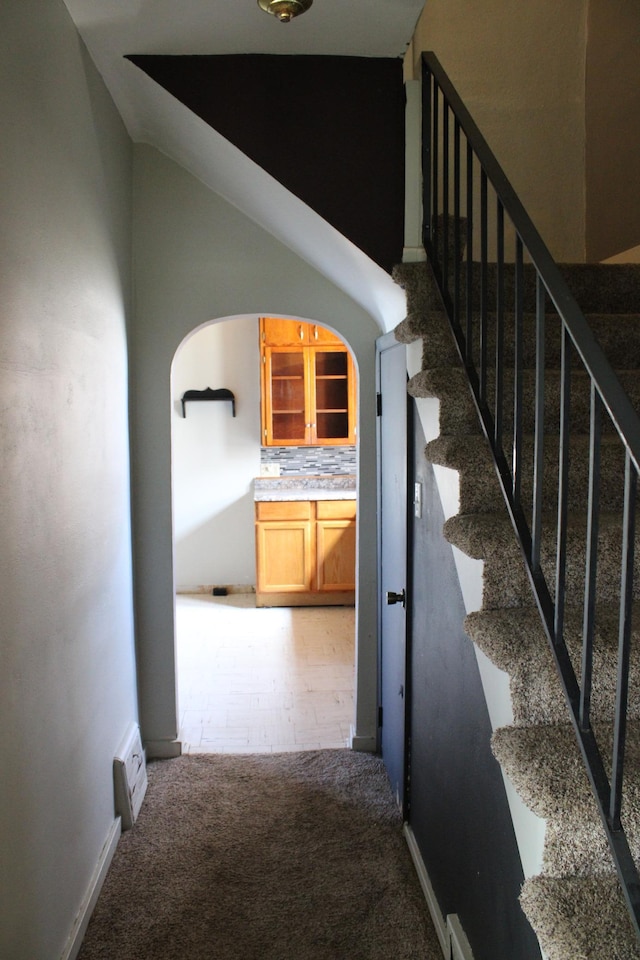 2612 3rd Ave W, Hibbing, MN 55746 - staircase featuring carpet flooring and arched walkways