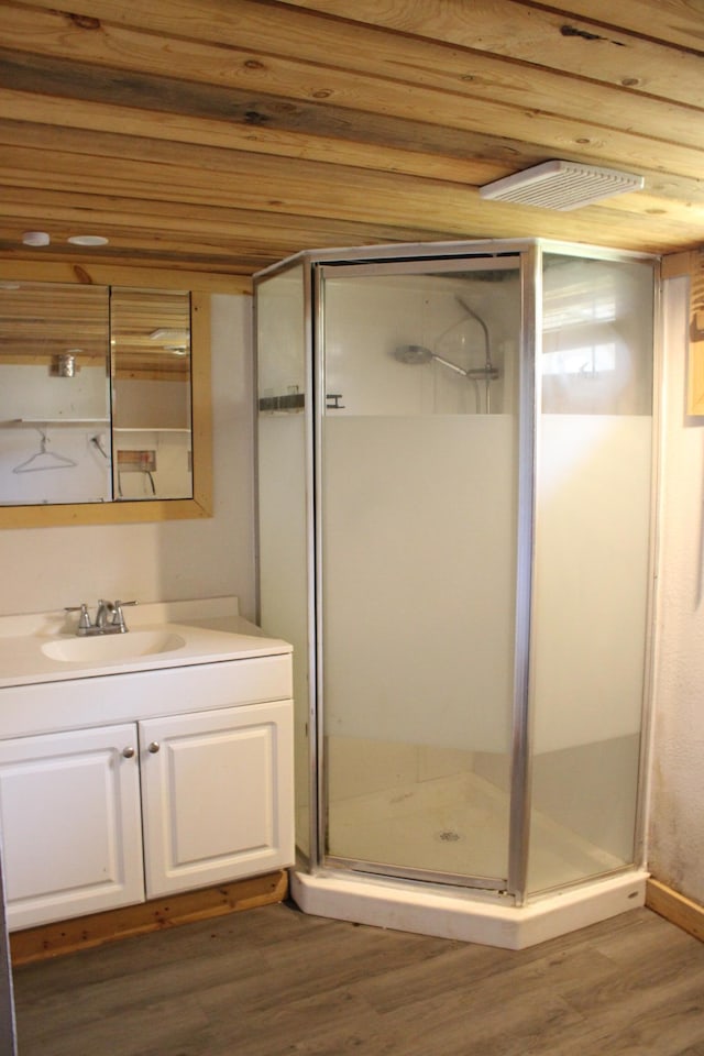 2612 3rd Ave W, Hibbing, MN 55746 - full bathroom with wood finished floors, vanity, and a stall shower