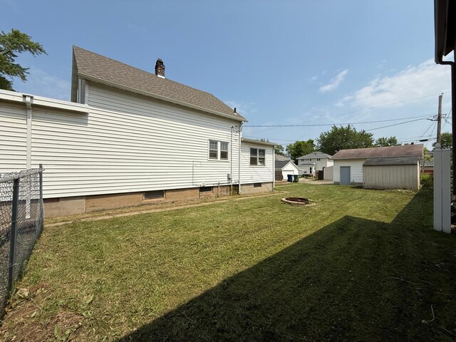2612 3rd Ave W, Hibbing, MN 55746 - view of yard featuring an outdoor fire pit and an outbuilding