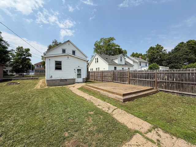 2612 3rd Ave W, Hibbing, MN 55746 - back of house featuring a fenced backyard and a wooden deck