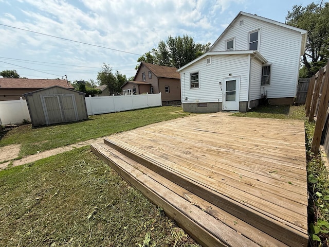 2612 3rd Ave W, Hibbing, MN 55746 - back of house featuring a deck, a fenced backyard, and a shed